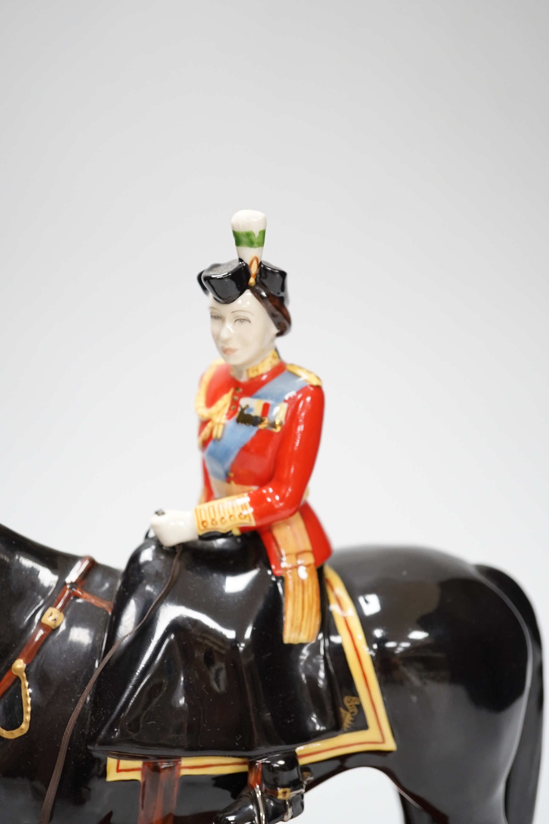 A Beswick ‘trooping the colour’ limited edition figure of Her Majesty The Queen on Burmese, on stand. 151/500
